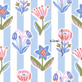 a repeating pattern of colorful flowers and leaves on a blue and white striped background.