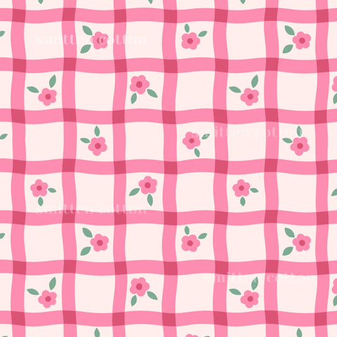 a repeating pattern of pink and white checkered squares, each containing a small pink flower and a green leaf.