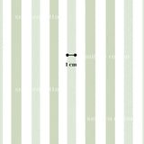 a single object, which is a small black dot, positioned in the center of a repeating pattern of green and white vertical stripes.