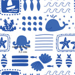 a blue and white pattern with a whale, starfish, and seaweed