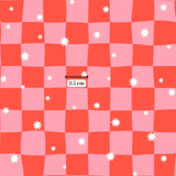 a pattern of pink and white squares with white stars scattered throughout, and there is a measurement scale in the center of the image indicating the size of the pattern.