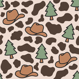 a repeating pattern of brown cowboy hats and green pine trees against a light brown background with brown spots.