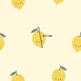 a repeating pattern of yellow lemons with smiling faces, and there is a measurement line indicating the size of the lemons.