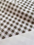 a close-up view of a fabric with a checkered pattern in shades of gray and white.