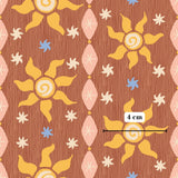 The image is a repeating pattern of stylized sun and flower designs on a wooden background.