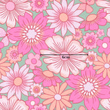 The image is a vibrant and colorful pattern featuring various pink and white flowers, including daisies and other blooms, against a green background.