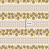 a repeating pattern of yellow flowers on a light beige background, with a measurement scale indicating the size of the pattern in centimeters.