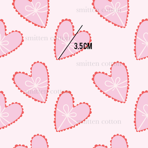 a pattern of hearts with a bow on a pink background