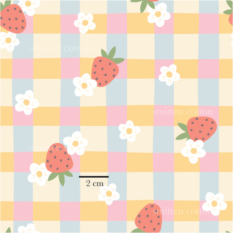 a pattern of strawberries and daisies on a checkered tablecloth