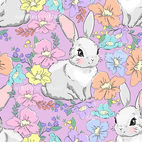 a repeating pattern of cartoon rabbits surrounded by colorful flowers and leaves in various shades of pink, yellow, blue, and orange.
