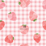 a pattern of strawberries on a checkered tablecloth
