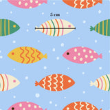 a pattern of colorful fish swimming against a blue background with white polka dots.
