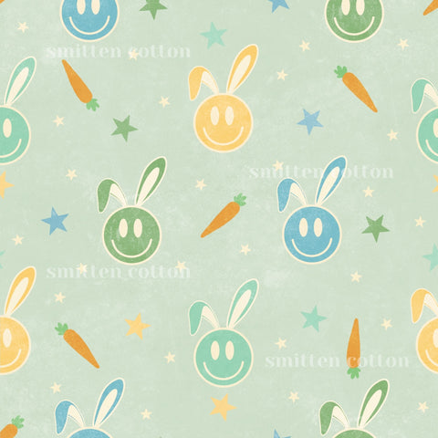 a repeating pattern of smiling rabbit faces and carrots against a light green background with stars.