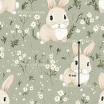 a repeating pattern of cartoon rabbits surrounded by white flowers and greenery. The rabbits are depicted in various poses, and the background is a light green color with white flowers scattered throughout. The image is a collage of multiple images, and the text "sitten cotton" is visible, likely indicating the source or creator of the pattern.