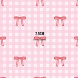 a pattern of red bows on a pink background