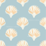 a pattern of orange and white seashells on a blue background