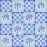 a blue and white quilt with a palm tree on it