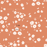 a pattern of white flowers on an orange background